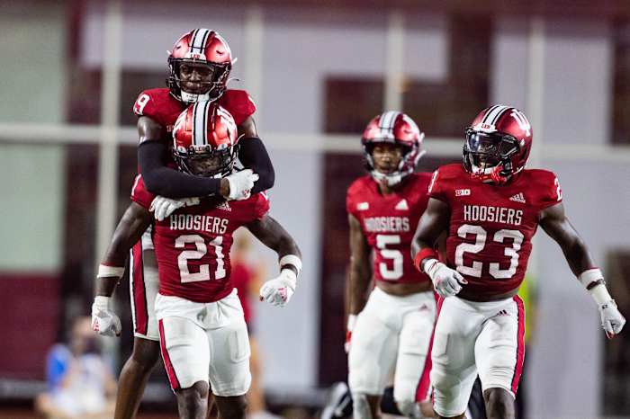 Noah Pierre (21) celebrates his fumble recovery with teammates.